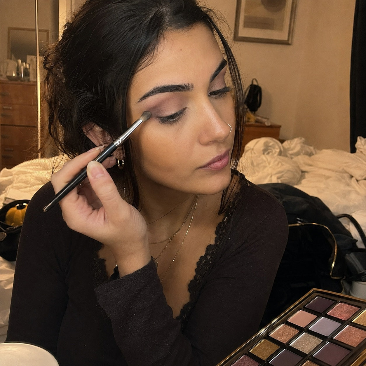 Soft smoky eye being blended with a brush before a night out