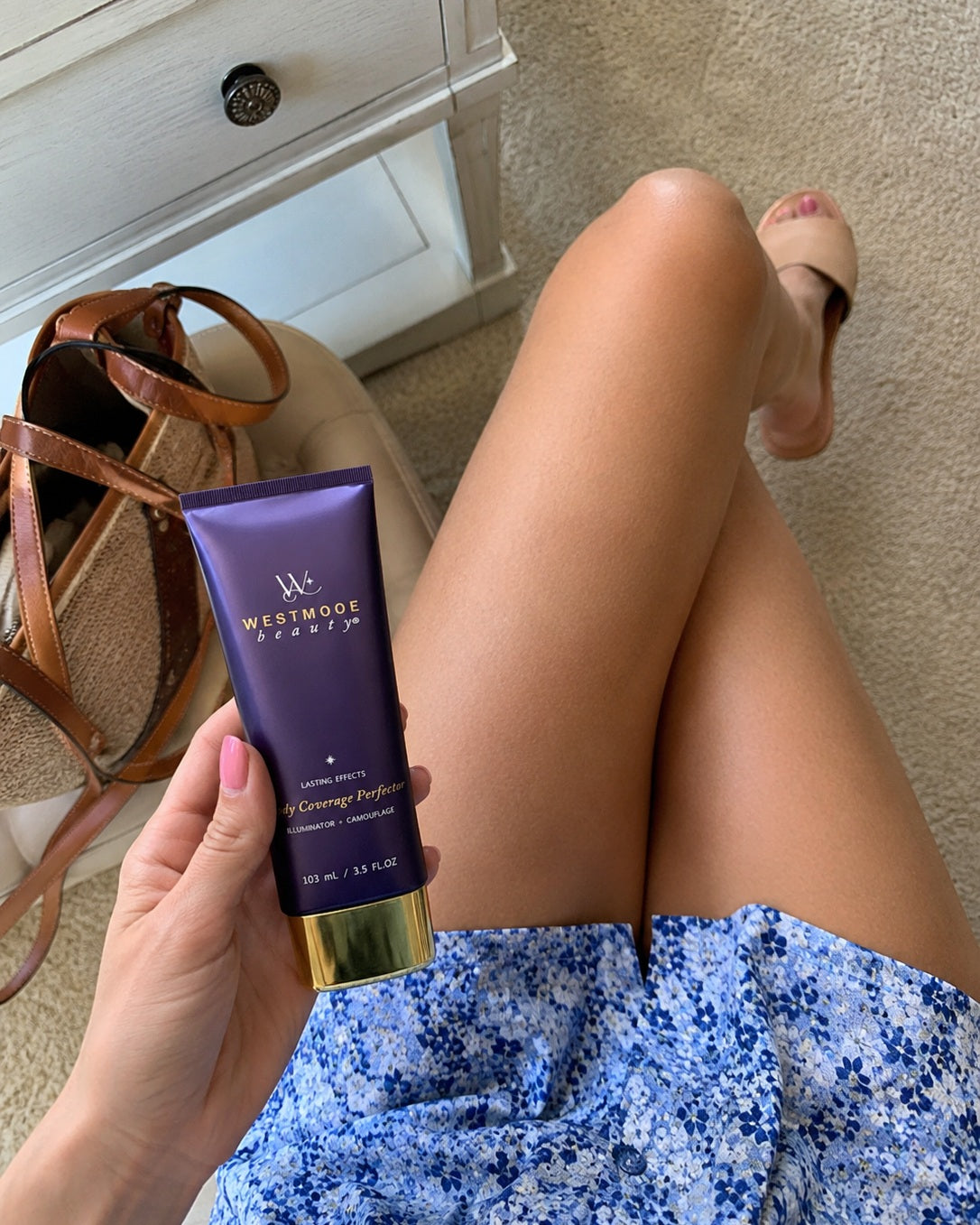 Customer holding Body Coverage Perfector with a summer outfit